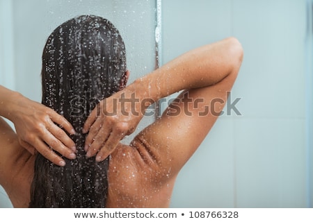 Foto stock: Woman Enjoying Water In The Shower Under A Jet