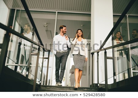 Stock fotó: Young Business Couple On The Stairs In Office