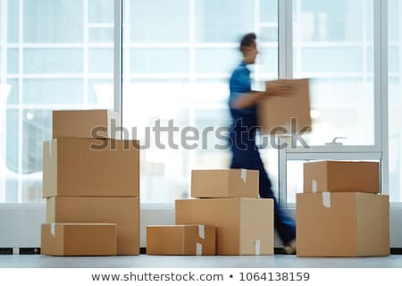 Stock foto: Young Man Employee With Boxes In The Office