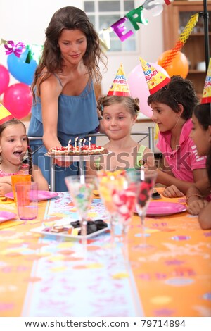 Stock photo: Time To Blow Out The Candles At A Childs Birthday Party 6 Year Old Boy Blows Out Candles On A Cake