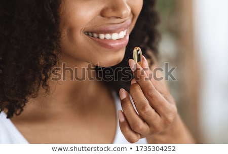 Сток-фото: Portrait Of Woman With Omega 3 Fish Oil Capsule