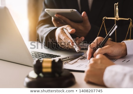 Stockfoto: Business People And Lawyers Discussing Contract Papers Sitting A