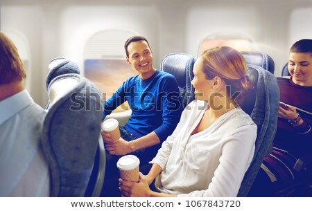 ストックフォト: Happy Passengers With Coffee Talking In Plane