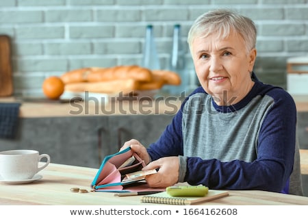 Сток-фото: Senior Woman Counting Money At Home