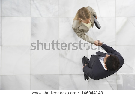 Stockfoto: Business Man And Business Woman In Office Lobby