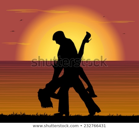 Stockfoto: Beautiful Young Couple Dancing Tango On The Beach At Sunset