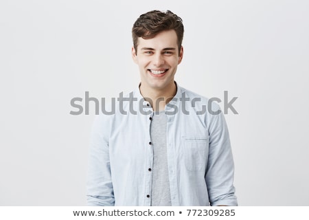 Stockfoto: Smiling Young Man With Blue Eyes