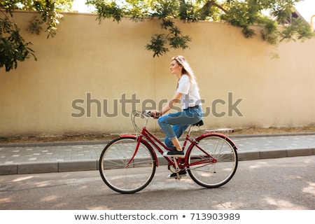 Zdjęcia stock: Portrait Of A Beautiful Woman Riding On Bicycle