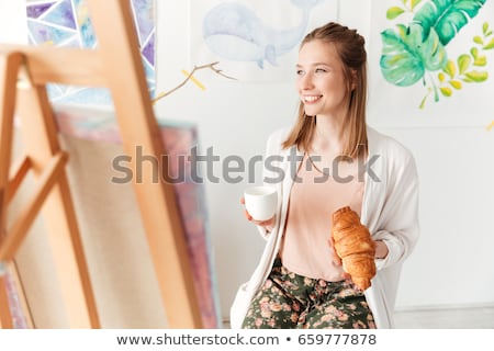 Stockfoto: Concentrated Young Caucasian Lady Painter At Workspace