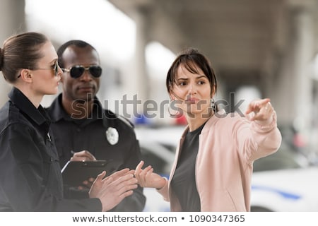 Foto stock: Young Policeman In Uniform Writing On Clipboard