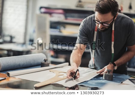 Stock fotó: The Young Tailor Working In His Workshop