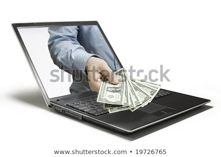 ストックフォト: Hand With Cash Coming Out Of A Laptop