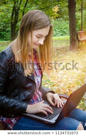 Stok fotoğraf: Woman Working Project On Laptop In Autumn Park