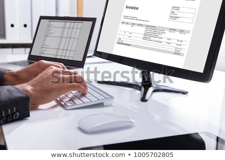 Stockfoto: Businessman Checking Invoice On Computer