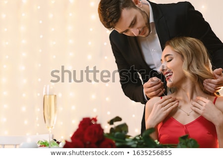 Stockfoto: Happy Man Puts Necklace On His Girlfriend