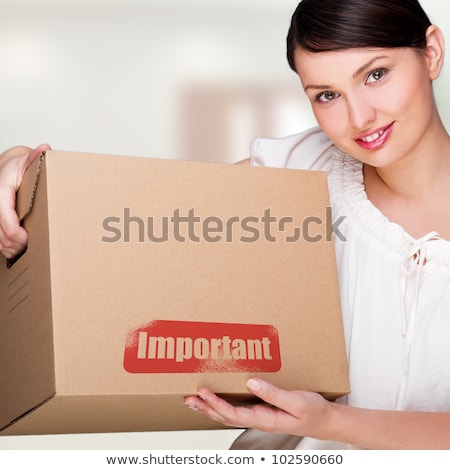 Foto stock: A Woman Holding A Box Inside Office Building Or Home Interior P