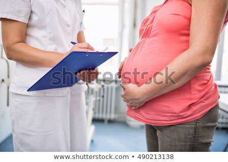 Zdjęcia stock: Doctor Measuring Weight Of Pregnant Woman