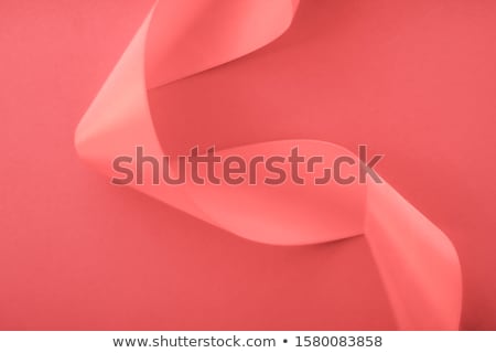 Foto d'archivio: Abstract Curly Silk Ribbon On Pink Background Exclusive Luxury