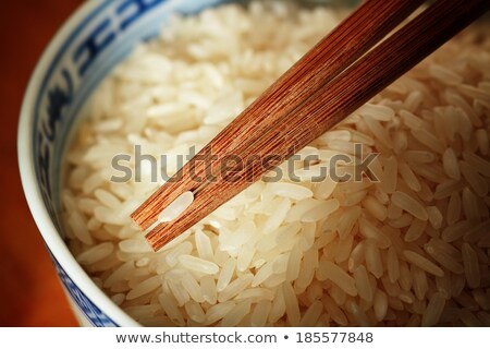 Stock photo: Uncooked Rice And Chopsticks