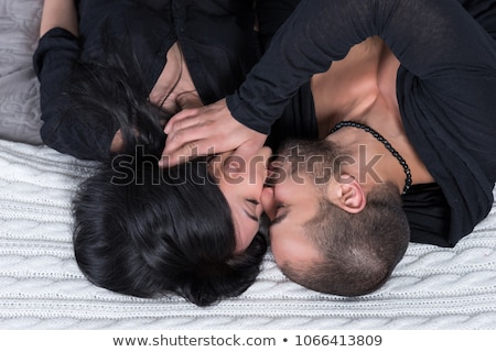 Stockfoto: Clothed Couple Kissing In Bed