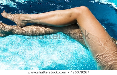 Foto d'archivio: Female Legs In The Water Pool