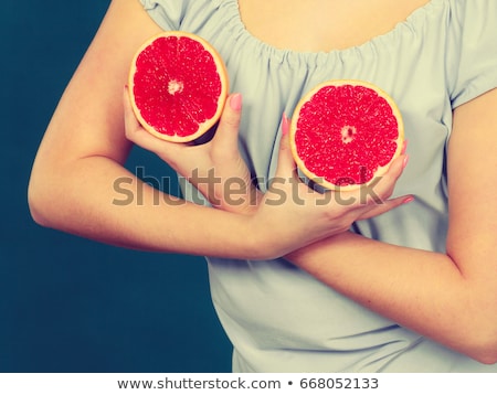 Foto stock: Red Woman Holding Grapefruit