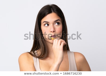 Stock fotó: Young Woman Brushing Teeth In Studio