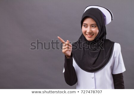 Foto stock: Asian Female Surgeon Pointing Finger To Head