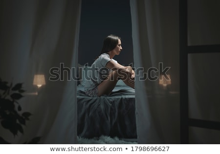 ストックフォト: Sad Woman Sitting On The Bed