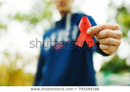 ストックフォト: Red Ribbon In The Palm Of A Man