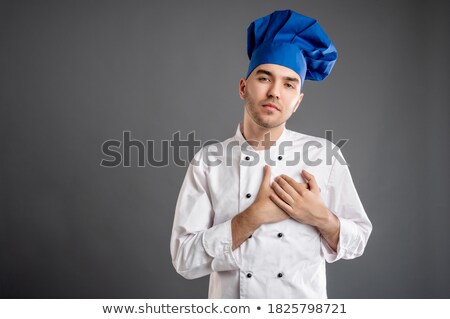 Foto d'archivio: Caucasian Chef Cook Holding Hand On His Chest