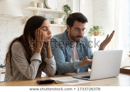 Stock fotó: A Worried Woman Looking At A Bill