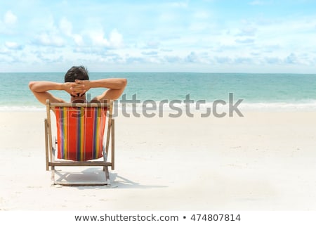 Foto stock: Man Relaxing At The Beach