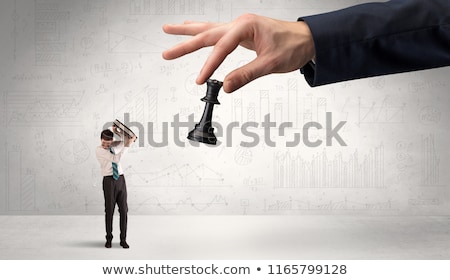 Stock photo: Businessman Is Afraid To Make The Next Step In A Chess Game With Graphs Background