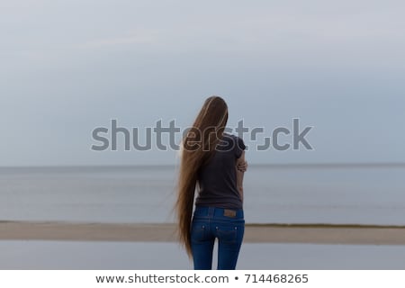 Сток-фото: Young Long Haired Teen Girl Standing On The Beach