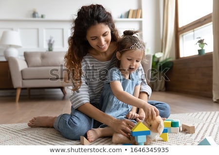 Foto stock: Happy Family Embracing And Sitting On The Floor In Front Of Chri