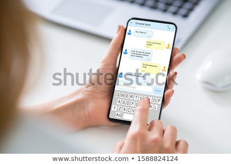 Stock photo: Woman Sending A Text Message