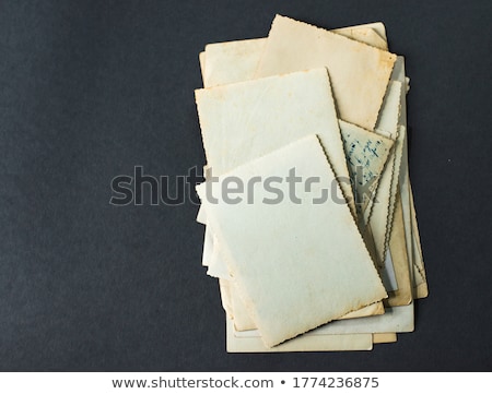 Stok fotoğraf: A Stack Of Old Postcards And Frames On A Wooden Table