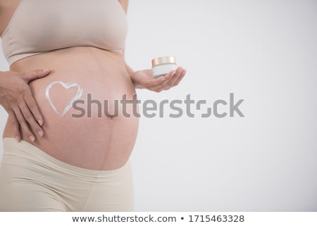 Foto stock: Pregnant Woman Touching And Rubbing Her Belly