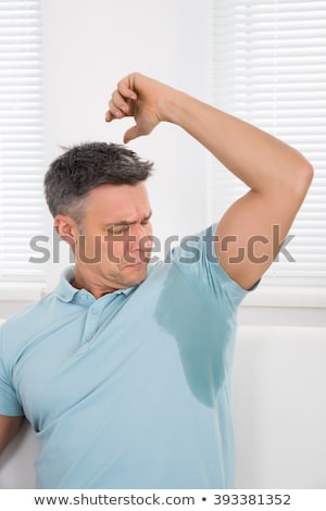 Foto stock: Man Noticing His Sweat Under Armpit