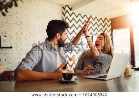 Foto stock: Couple Looking Into Laptop