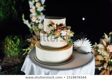 Stok fotoğraf: Wedding Cake Three Floors With Fruit Outside In The Evening