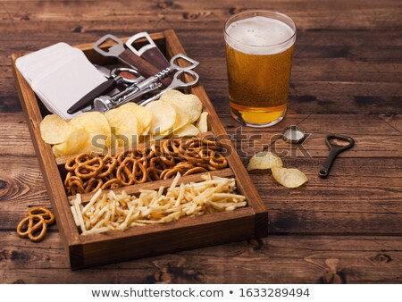 Foto stock: Glass Of Lager Beer With Potato Crisps Snack On Vintage Wooden Board On Black Background Beer And S