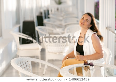 Stock fotó: Moderately Obese Businesswoman Sitting In A Cafe While Holding Coffee