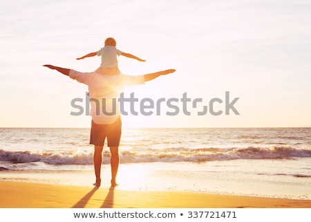 Stockfoto: Happy Father And Son Having Quality Family Time On The Beach On Sunset On Summer Holidays Lifestyle