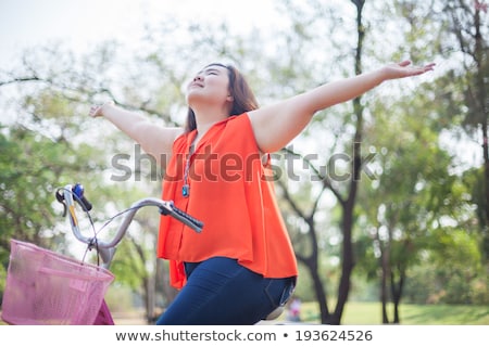 Stock fotó: Happy Fatty Woman Posing With Bicycle