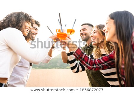 Stock photo: Man And Woman Clink Glasses On Sunset Outside