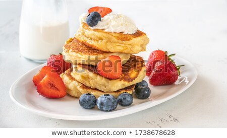 Foto stock: Portion Of Ricotta Fritters With Fresh Berries