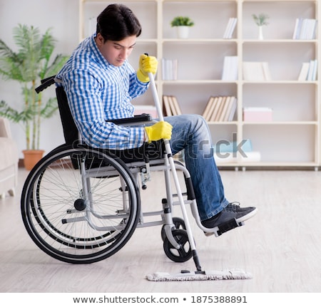 Сток-фото: The Disabled Man Cleaning Floor At Home