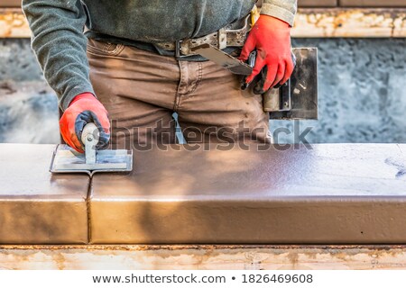 ストックフォト: Construction Worker Using Hand Groover On Wet Cement Forming Cop